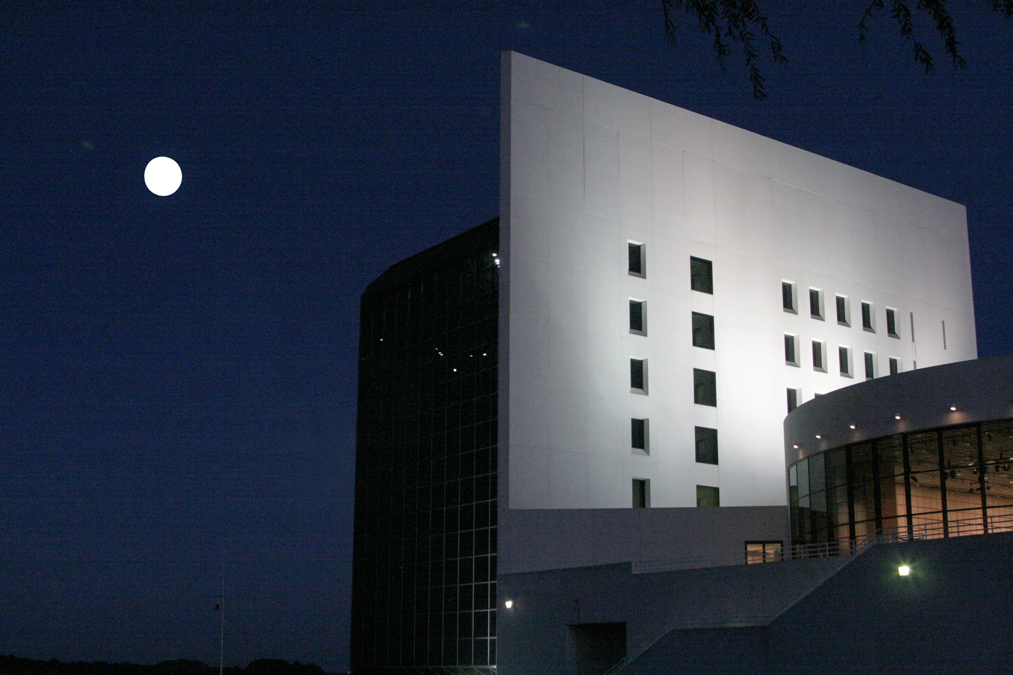 The rear of the JFK Library with the Moon visible 